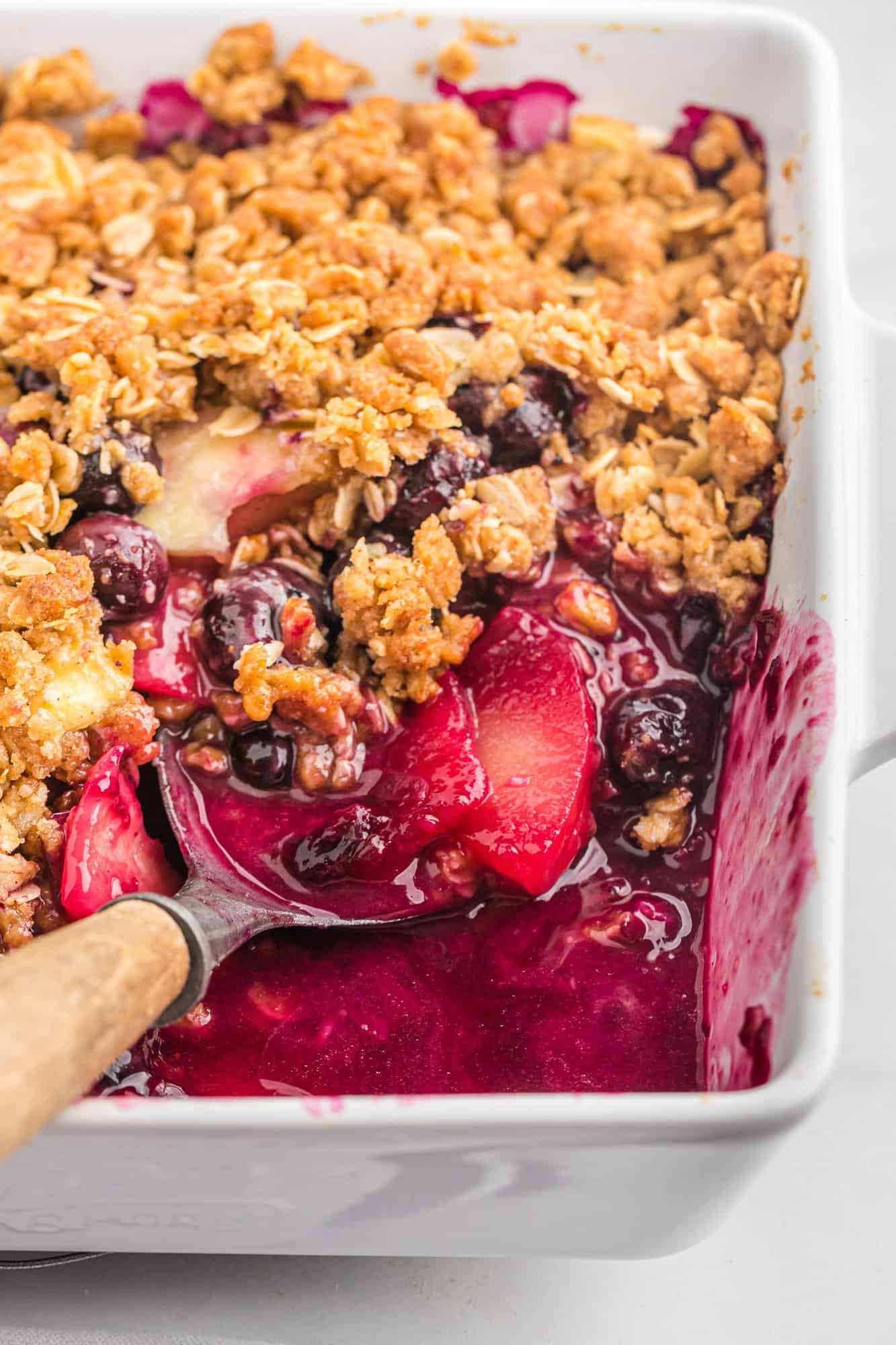 apple-blueberry-crisp-cast-iron-pan-2 Apple Blueberry crisp with a scoop out to show texture.