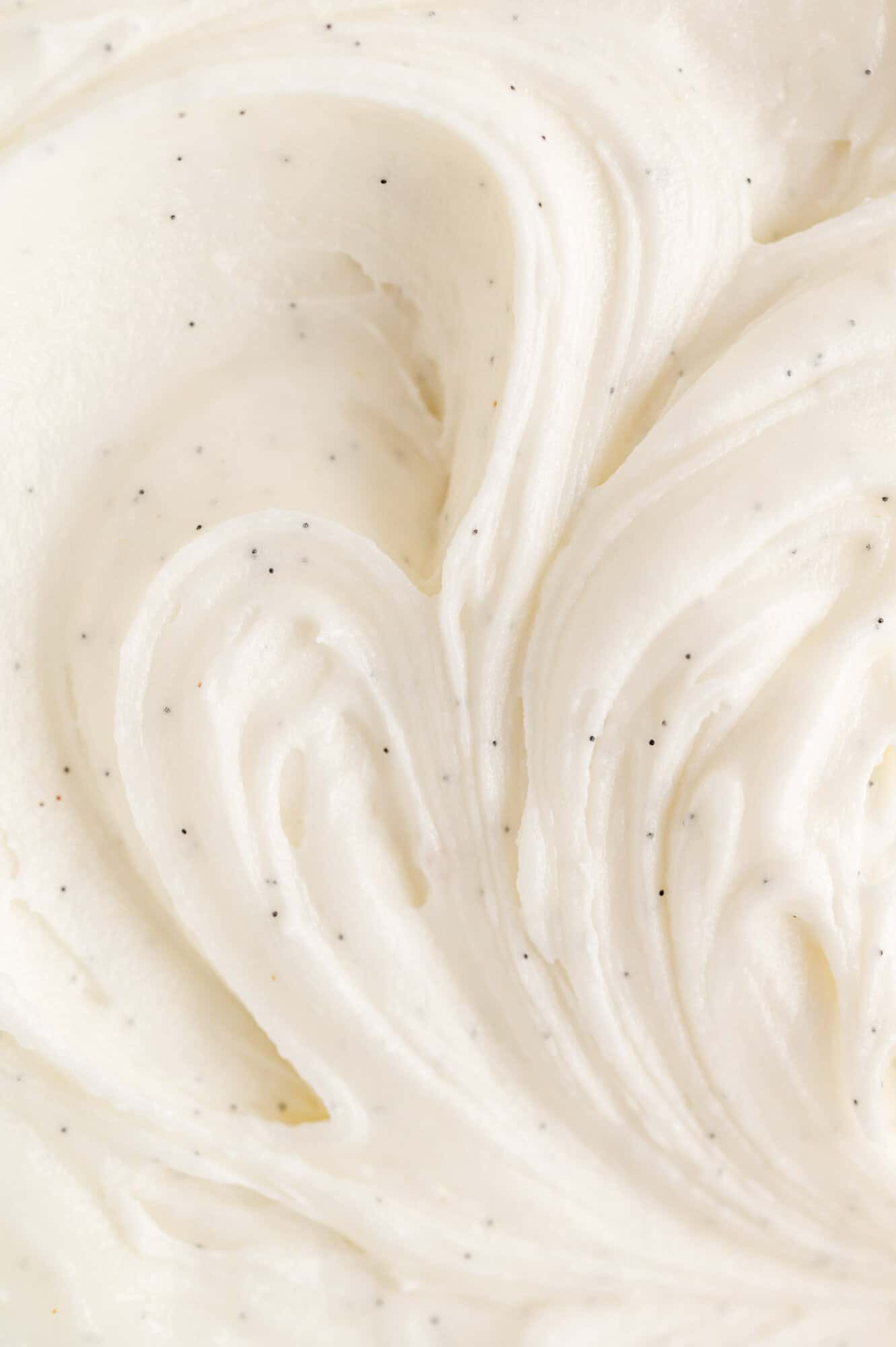Close up of vanilla buttercream frosting with real vanilla seeds.