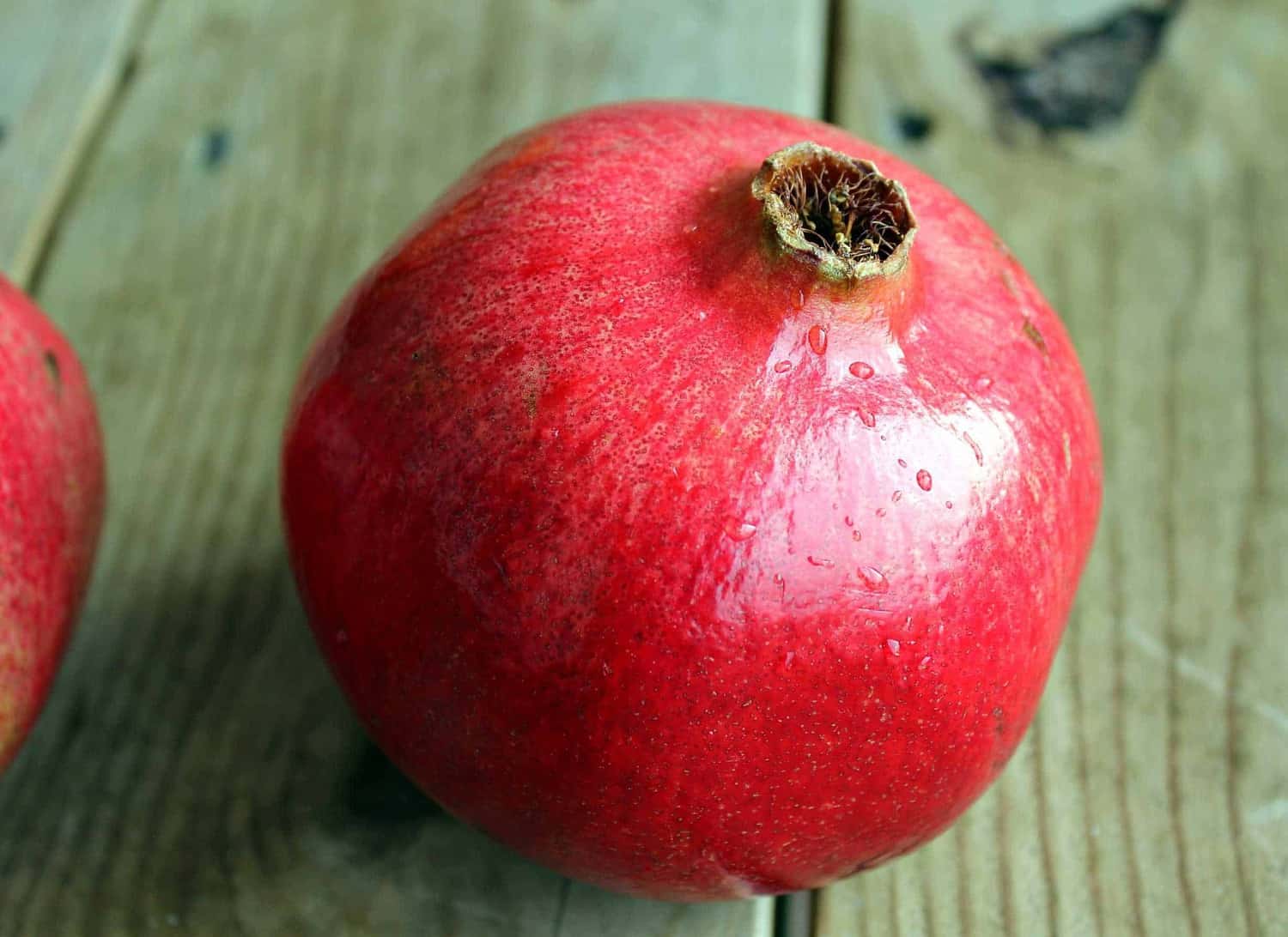 Fresh pomegranate on a wooden surface.