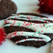 Chocolate cookie with white chocolate drizzle and christmas sprinkles.
