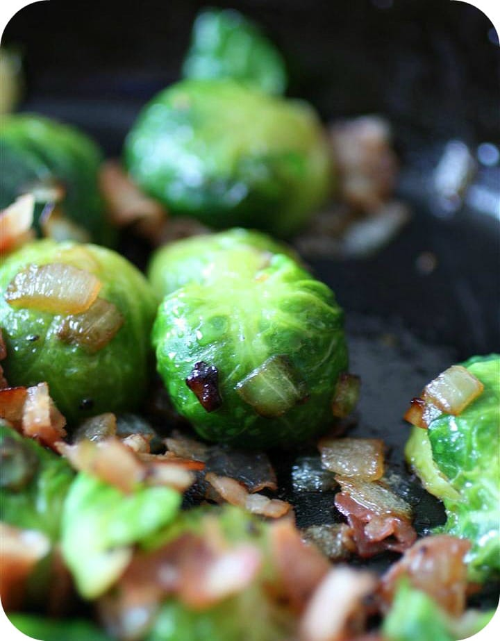 Closeup of Brussels sprouts and pancetta in skillet.