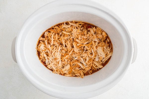 Shredded salsa chicken inside the crockpot.