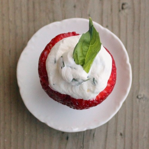 Overhead view of a strawberry stuffed with basil whipped cream.