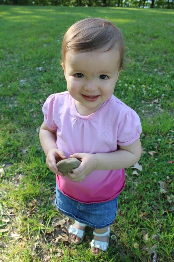 The author's adorable baby girl holding a rock.