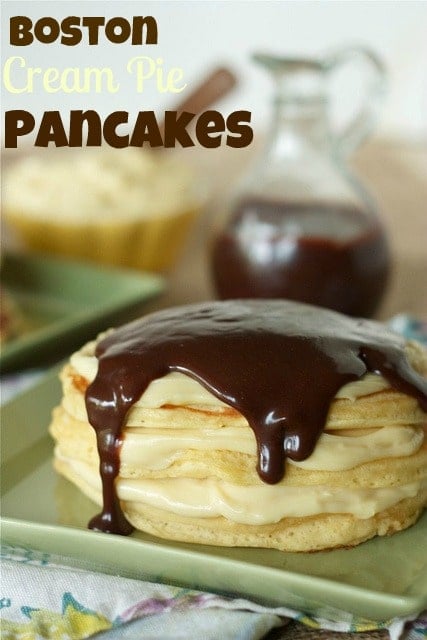 Stack of pancakes, with pastry cream and ganache, on square green plate. Text overlay reads "Boston cream pie pancakes."