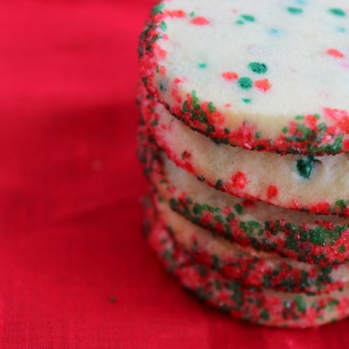 Stack of funfetti cookies on a red background.