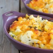 Partial image of potato cauliflower bake in individual purple ramekins.