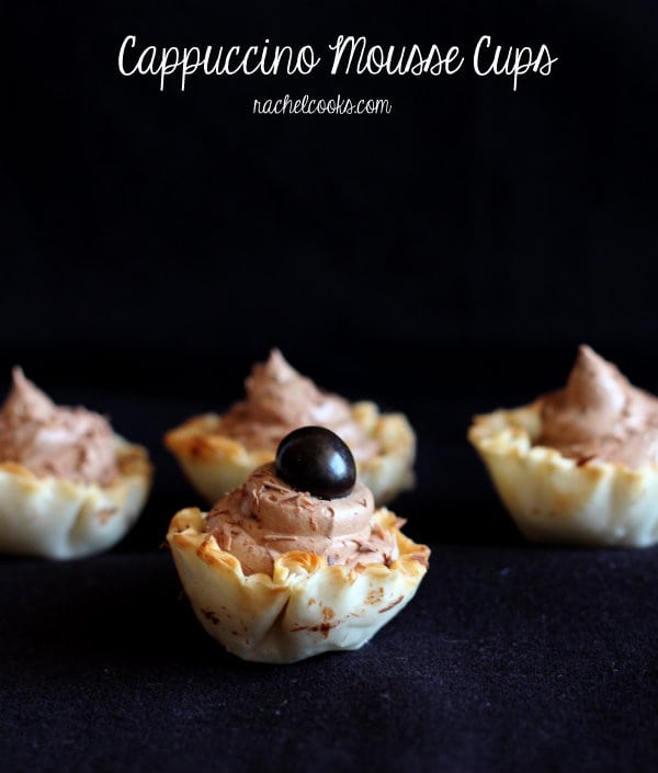 Front view of 4 mousse cups on. nearly black background, with text overlay that reads "Cappuccino Mousse Cups. RachelCooks.com"