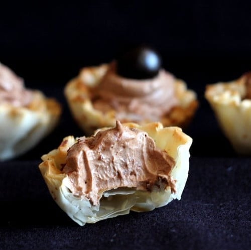 Close up of mousse cups, one partially eaten.