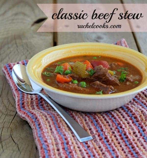 Stew in a yellow bowl on a white background. Text overlay reads "classic beef stew, rachelcooks.com'"