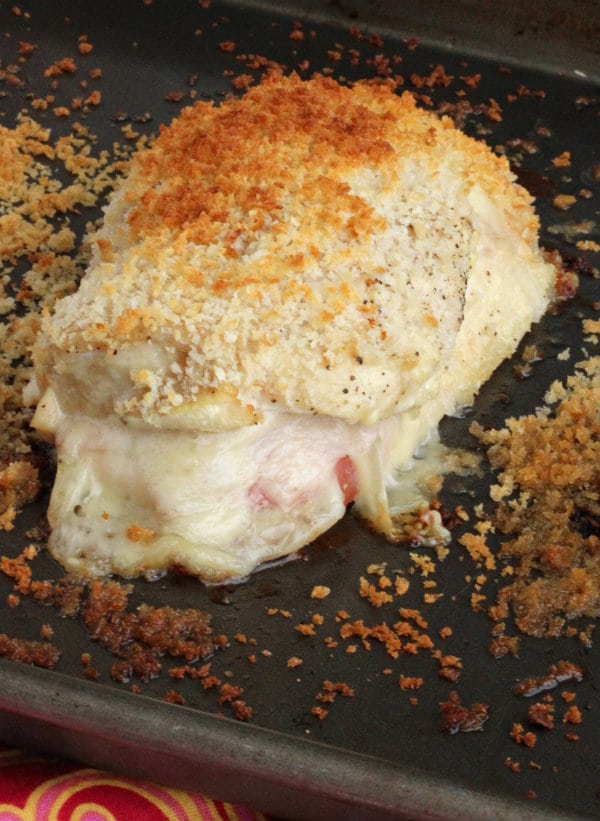 Closeup of single serving of baked chicken in sheet pan.