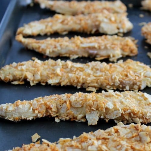 Front view of several chicken tenders in baking pan.