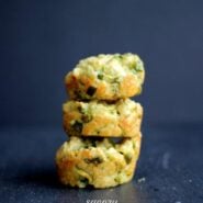 Stack of three muffins on dark gray surface.