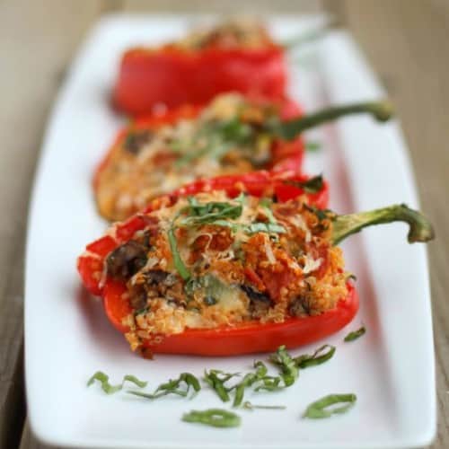 Image of quinoa stuffed bell peppers with pepperoni, mushrooms, cheese, and pizza sauce.