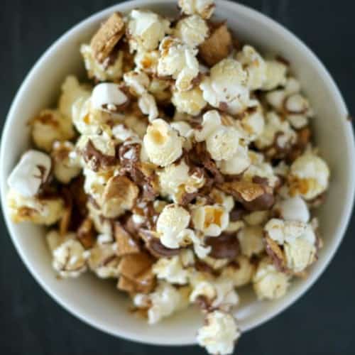 Overhead of round white bowl containing s'more