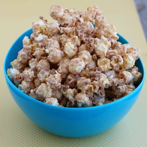 Round blue bowl holding Biscoff popcorn.