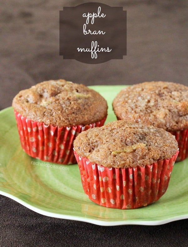 Three apple bran muffins with red liners on a green plate. Text overlay reads "apple bran muffins."