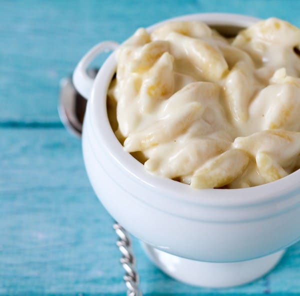 White cheddar mac and cheese in a white crock style bowl.