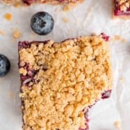 Overhead shot of a blueberry crumb bar bitten in the corner.