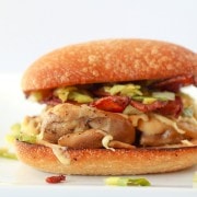 Chicken Burger with Bacon, Gouda and Leeks - close up image on a white background.