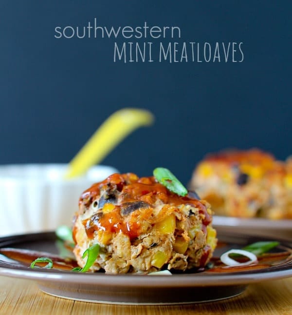 Front view of one meatloaf on brown plate, garnished with slice green onion. Text overlay reads "southwestern Mini Meatloaves."