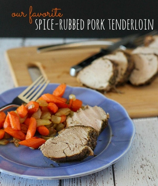 Image of sliced spice rubbed pork tenderloin on a blue plate with carrots and onions and a fork. In the background, more sliced pork tenderloin is pictured on a cutting board with a knife. Also in the image is a text overlay that reads "our favorite spice-rubbed pork tenderloin."