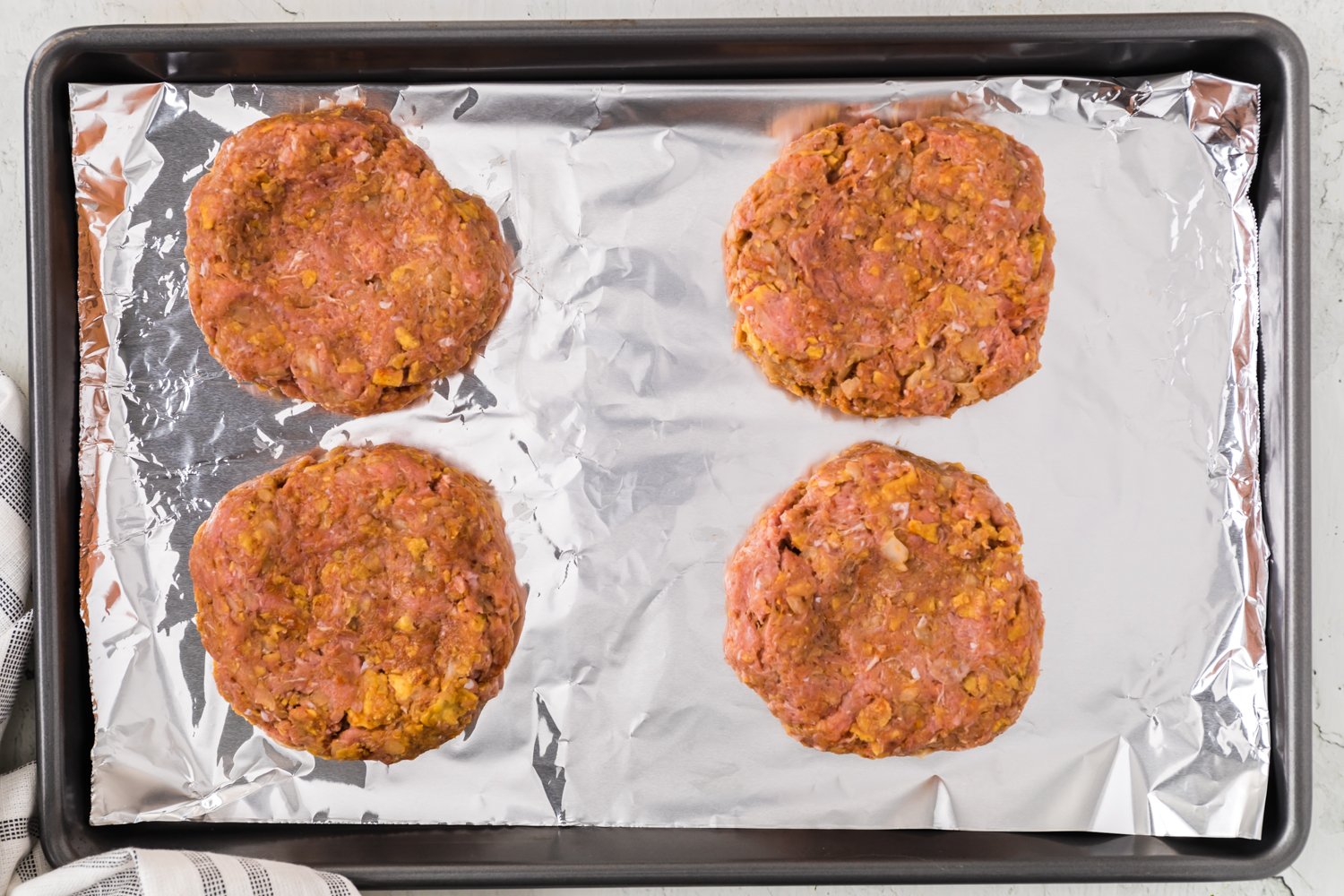 Uncooked burger patties.