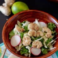 Overhead view of kale salad in wooden salad bowl.