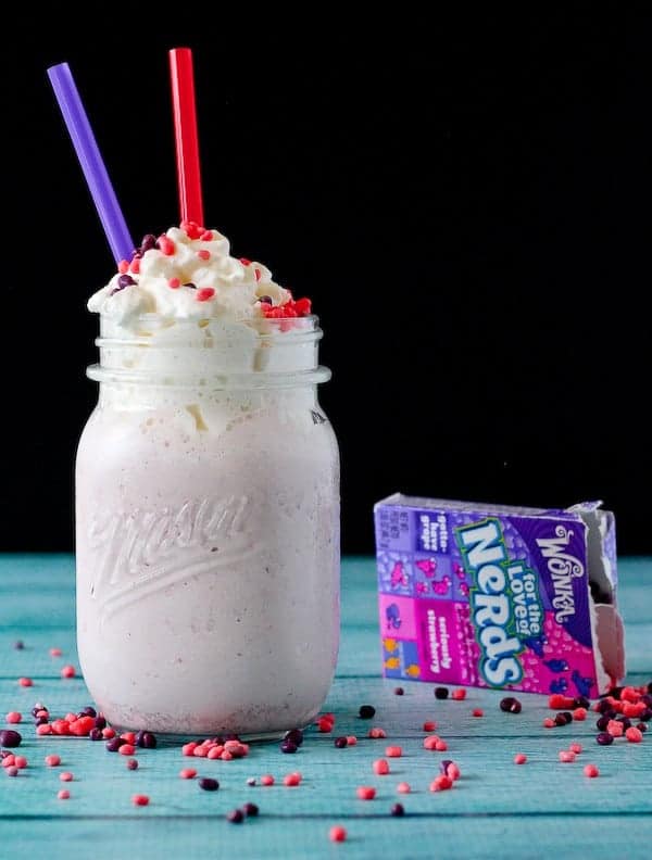 Nerds milkshake, with a box of spilled Nerds next to it.