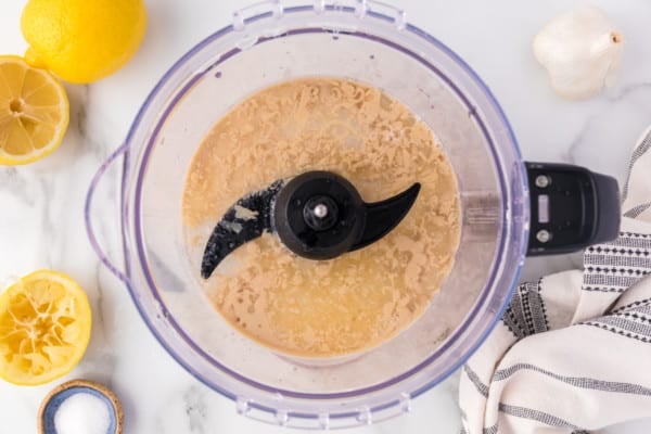 Tahini ingredients blended inside a food processor.