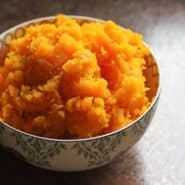 Small decorative bowl containing cooked mashed squash.
