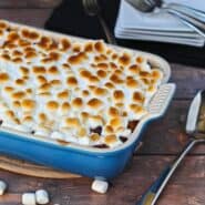 Partial image of sweet potato bread pudding in blue baking dish