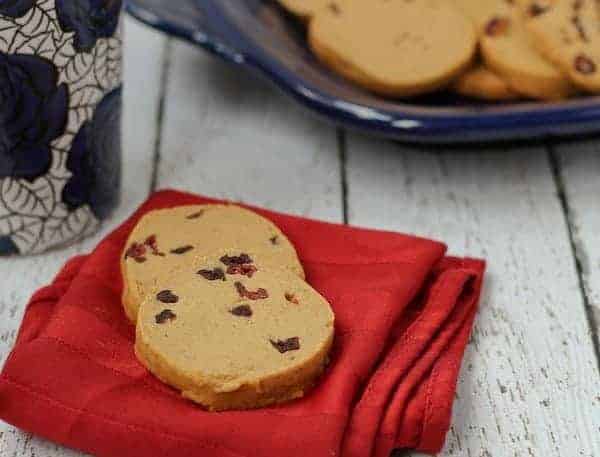 Front view of 2 gingerbread shortbread cookies on folded red napkin.