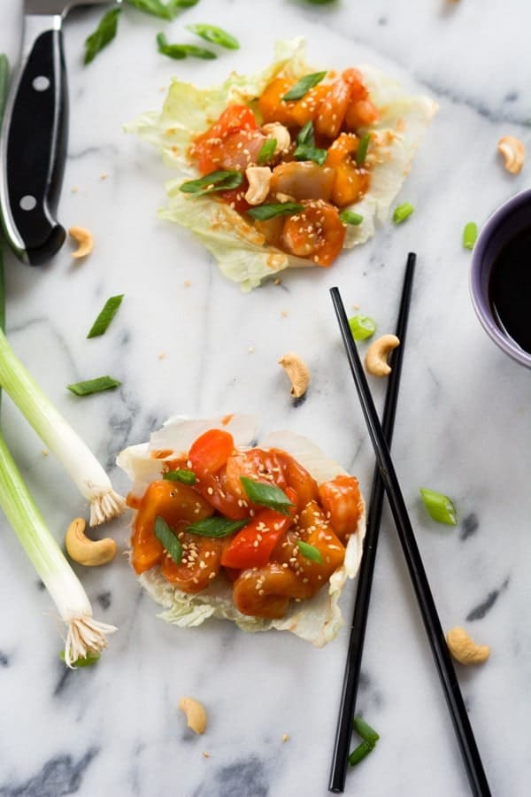 This healthier spin on your favorite Chinese takeout! These Sweet and Sour Shrimp Lettuce Wraps will be ready quicker than calling up an order! Get the recipe on RachelCooks.com!