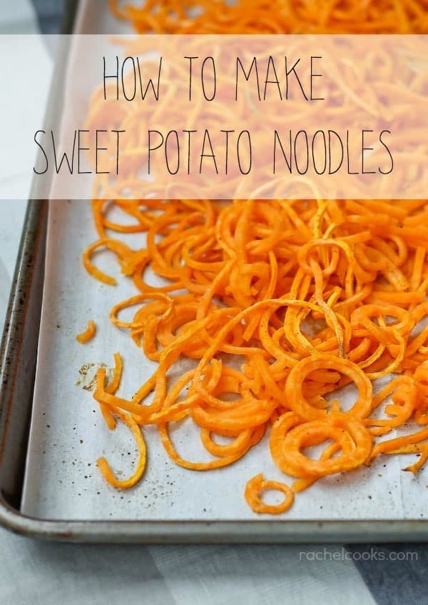 Pictured is the corner of a rimmed baking sheet, lined with parchment paper, and covered by sweet potato noodles. Also in the image is a text overlay that reads "How to Make Sweet Potato Noodles."