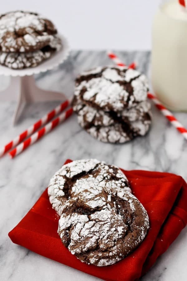 Cookies on red napkin, more cookies in background.