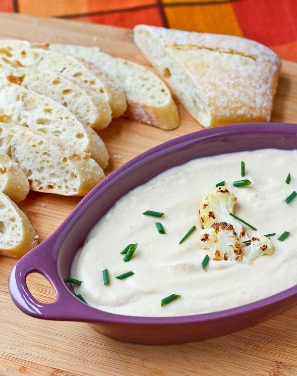 This roasted cauliflower and cheddar dip is unbelievably creamy and flavorful - blending the cauliflower into a silky dip helps greatly reduce the calories in this dip. Get the easy recipe on RachelCooks.com!