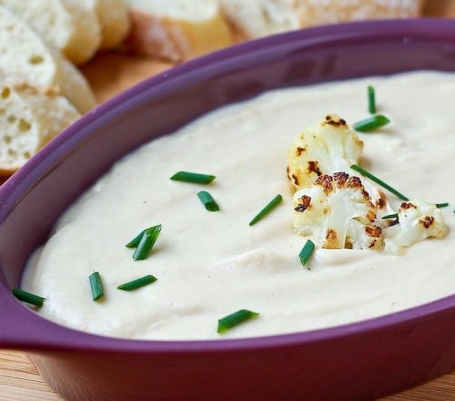 This roasted cauliflower and cheddar dip is unbelievably creamy and flavorful - blending the cauliflower into a silky dip helps greatly reduce the calories in this dip. Get the easy recipe on RachelCooks.com!