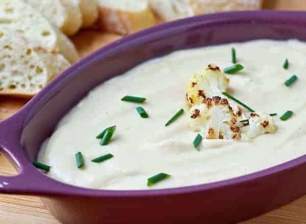 This roasted cauliflower and cheddar dip is unbelievably creamy and flavorful - blending the cauliflower into a silky dip helps greatly reduce the calories in this dip. Get the easy recipe on RachelCooks.com!