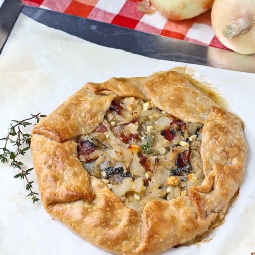 Vidalia Onion Tart with Bacon, Kale, and Thyme - aka the best thing you'll ever eat. Get the easy recipe on RachelCooks.com!