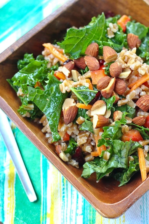 This kale salad keeps really well in your fridge - great for healthy eating all week! The honey dijon dressing softens the kale perfectly. Get the healthy recipe on RachelCooks.com. Great for weekly meal prep fans!