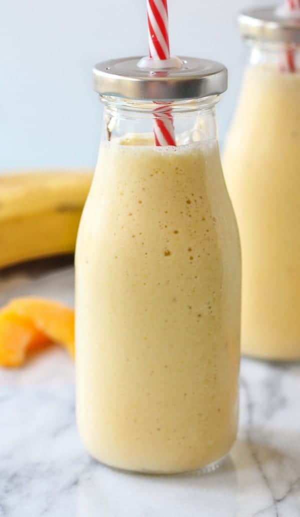 Cottage cheese smoothie in a tall bottle with a straw.