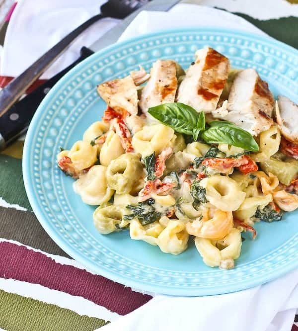 Tortellini with Creamy Sun-Dried Tomato Sauce and Spinach is a weeknight meal or a meal to impress guests! You'll love the flavor the sun-dried tomatoes add to the sauce! Get the easy recipe on RachelCooks.com!