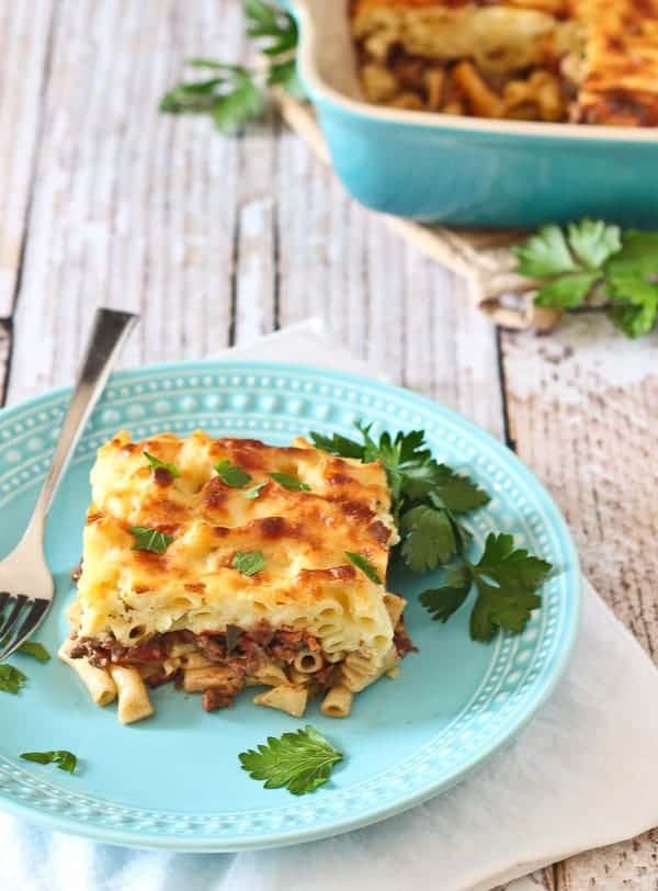 Serving of pastitsio on decorative plate.