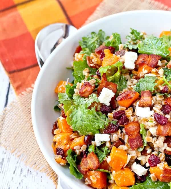 Partial overhead of round dish containing farro salad.