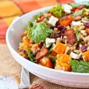 Partial front view of farro salad in shallow white bowl.