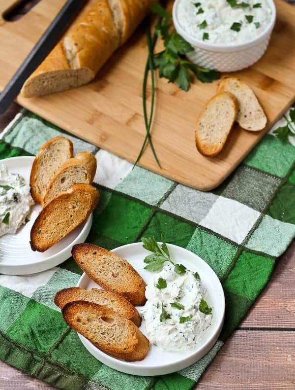 This herbed feta dip recipe will be the star of your next holiday gathering! It's tangy and unbelievably flavorful thanks to tons of fresh herbs - including one that may surprise you! Get the easy appetizer recipe on RachelCooks.com!