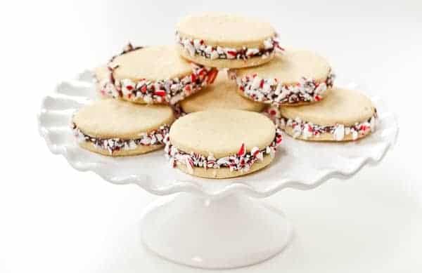 These Peppermint Sugar Cookie Sandwiches with Chocolate Ganache are easy to make and a gorgeous addition to your holiday cookies. Get the recipe on RachelCooks.com!