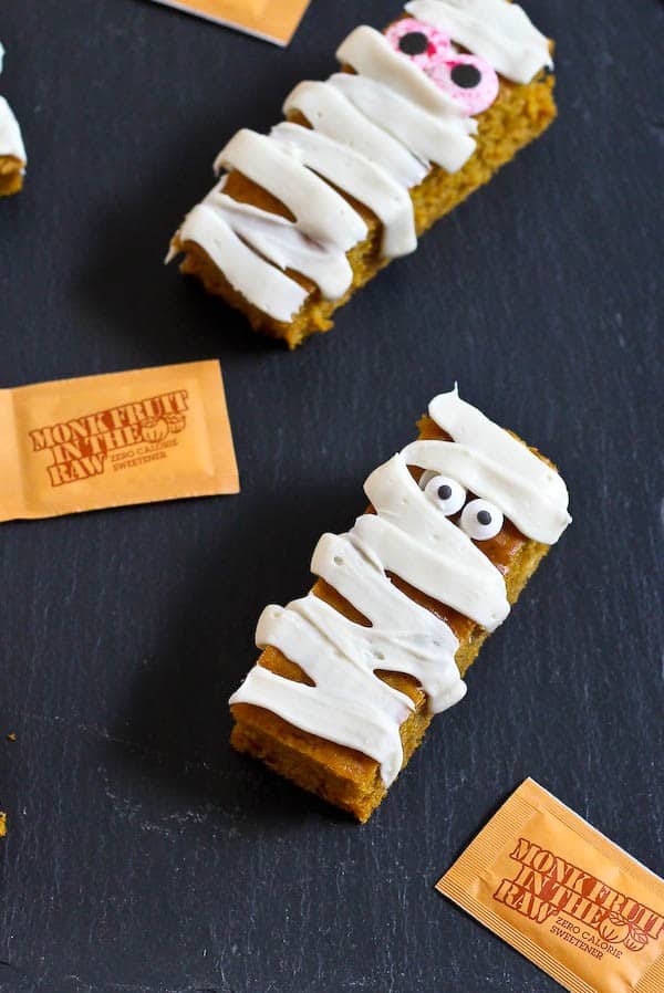 Don't throw a Halloween party without these fun pumpkin bar edible mummies. They use a lessened amount of sugar and are low in fat so you can maybe even eat two mummies! Get the easy recipe on RachelCooks.com!