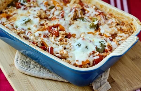 Baked casserole in baking dish on hot pad.